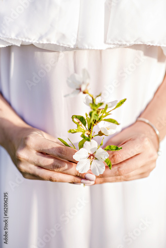 Hands of a young girl with flowers