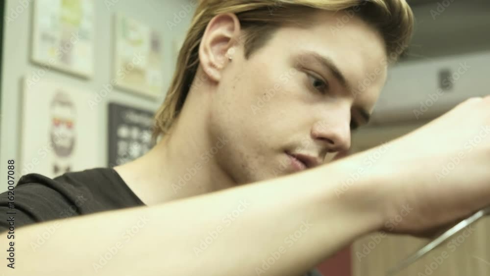 Men's hairstyling and haircutting in a barber shop or hair salon. Barbershop. Man hairdresser doing haircut men in the men's hair salon. Men's hairstyling and haircutting in a barber shop or hair salon. Barbershop. Man hairdresser doing haircut men in the men's hair salon.