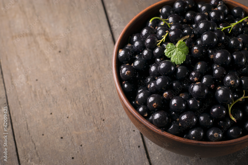 Black currant on a wooden background Black currant on a wooden background