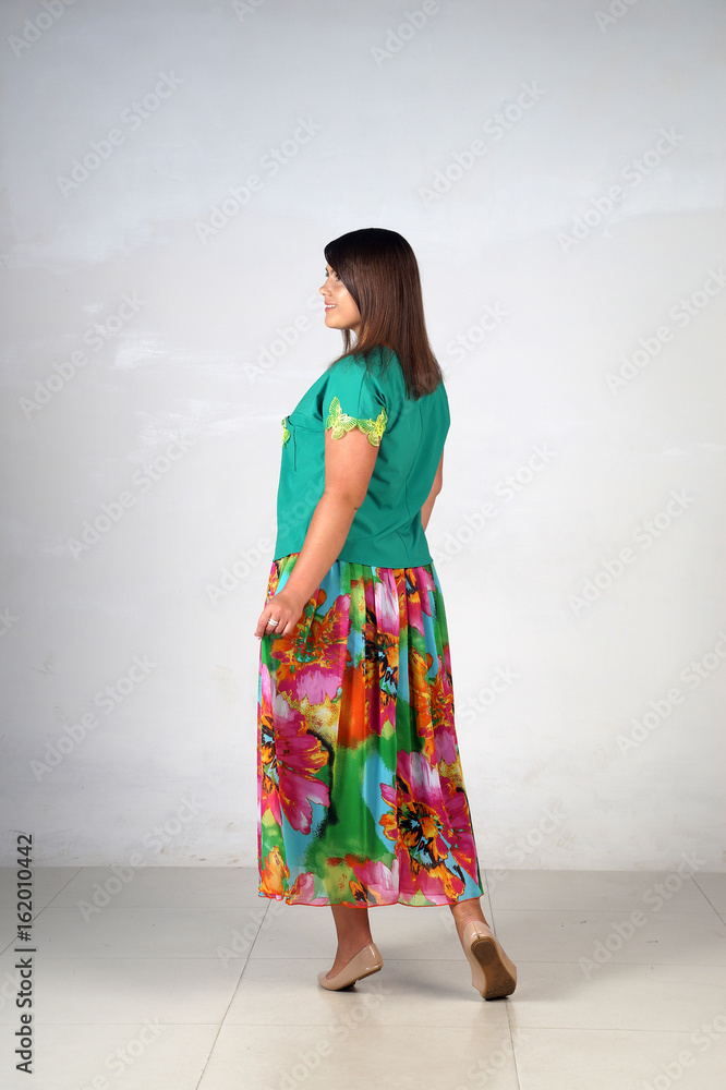 Beautiful young girl posing on a grey background Beautiful young girl posing on a grey background