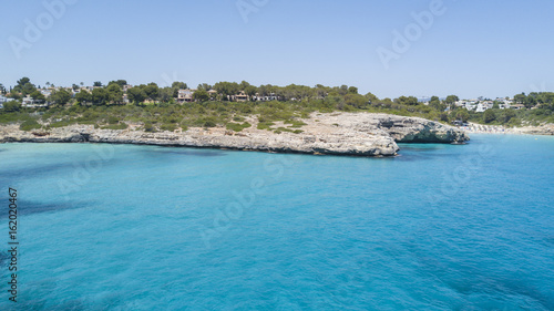 Landscape of the beautiful bay of Cala Mandia with a wonderful turquoise sea,Porto Cristo, Majorca, Spain photo