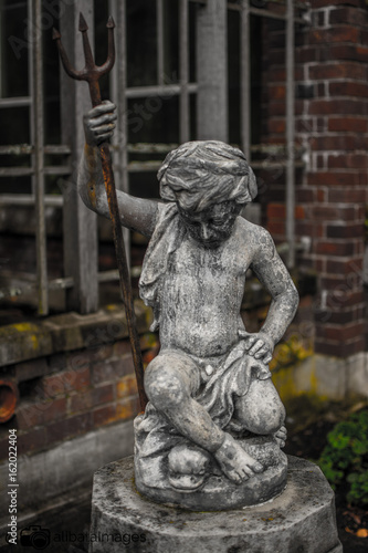 boy statue with scepter