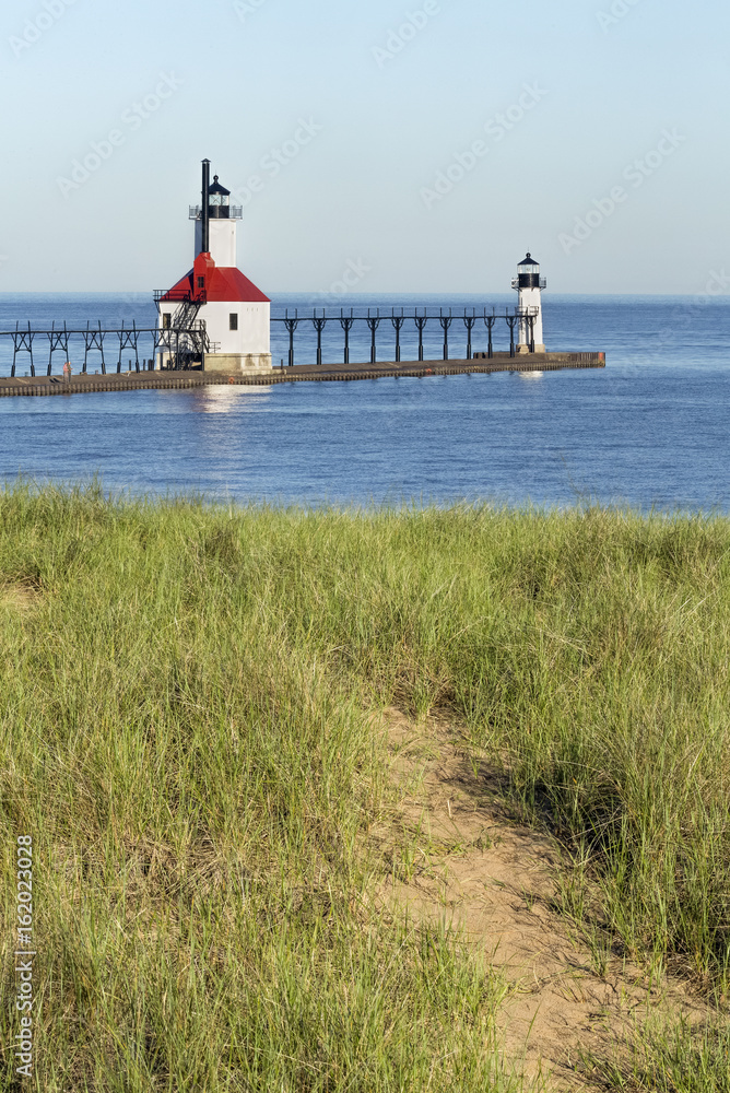 The North Pier Inner and Outer Lighthouses at St. Joseph, Michigan are viewed from a trial in the dunes overlooking Lake Michigan.
