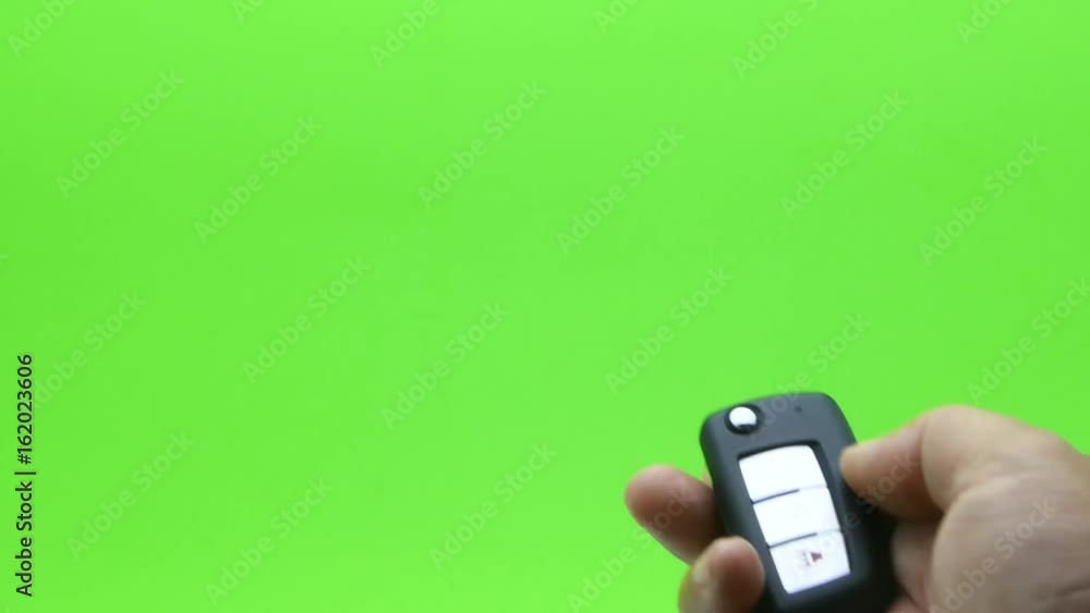 hand presses car keys on green screen hand presses car keys on green screen
