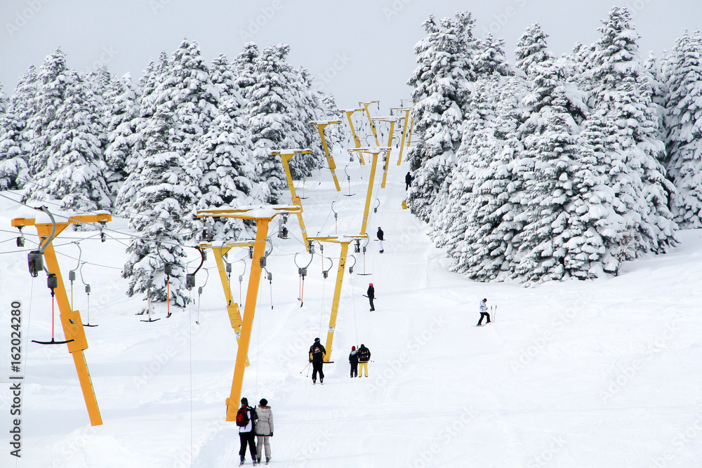 Winter resort with ski lift and ski tracks
