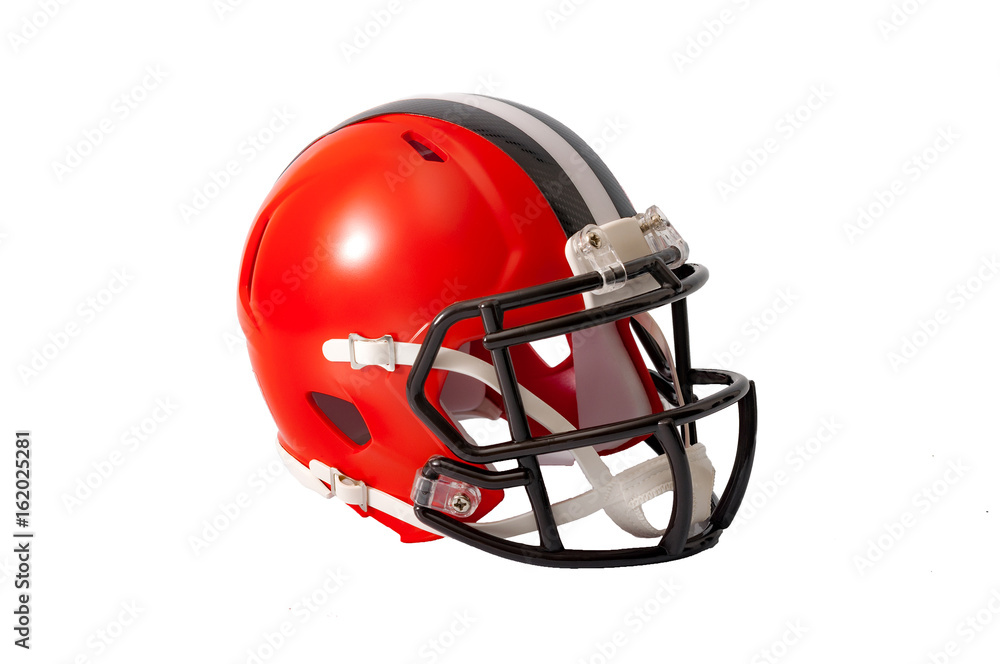Red or orange american football helmet with black and grey stripe along the crown of the helmet isolated on a white background Red or orange american football helmet with black and grey stripe along the crown of the helmet isolated on a white background