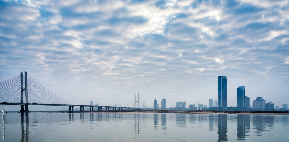 Naklejka premium River And Modern Buildings Against Sky in Tianjin,China.