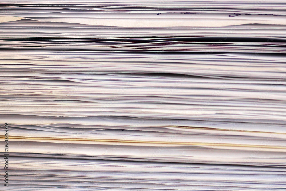 Stack of files full of documents signifying concepts such as work and stress, and business objects. Stack of files full of documents signifying concepts such as work and stress, and business objects.