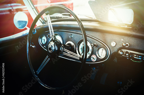 Interior view of classic vintage car. Instagram toning. Beautiful retro car poster, postcard.