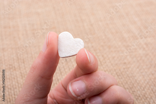 Heart shaped object in hand