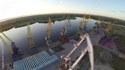  Port. Sunset. Dawn. Freight cranes. Aero video shooting. Shooting from the air. Ships.