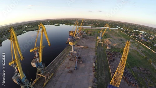  Port. Sunset. Dawn. Freight cranes. Aero video shooting. Shooting from the air. Ships.