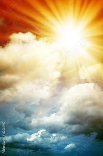 Abstract. Fog and clouds looking up into a fantasy multicolored sky. The bright red sun illuminates the whole picture.