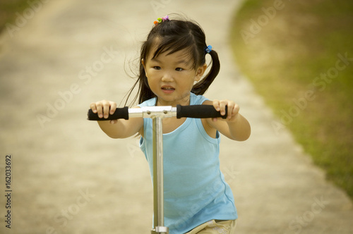 Girl riding on kick scooter