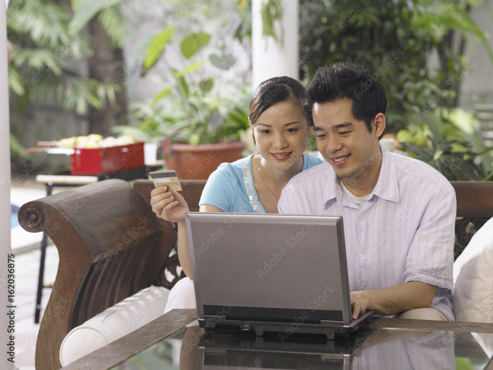 Men and woman spending time together making payment on line Men and woman spending time together making payment on line