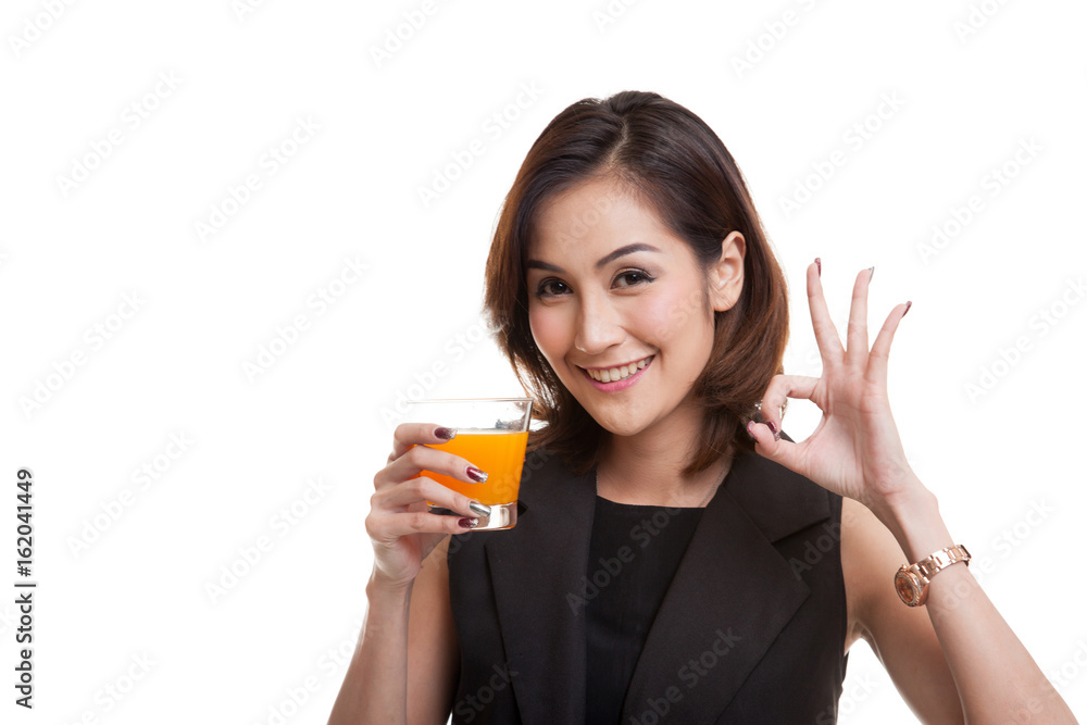 Young Asian woman drink orange juice show OK sign. Young Asian woman drink orange juice show OK sign.