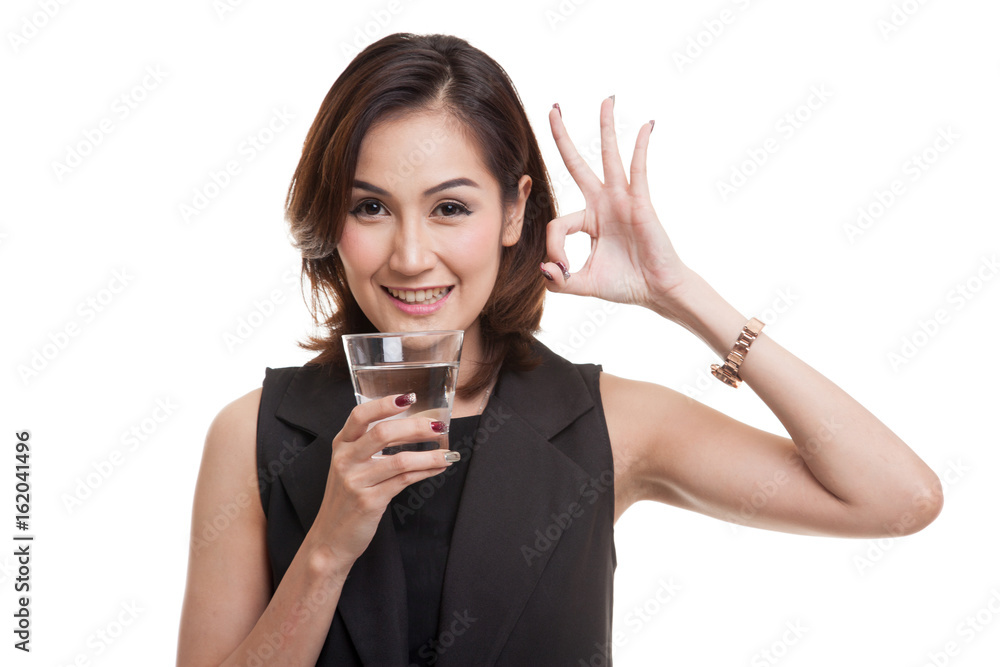 Young Asian woman show OK with a glass of drinking water. Young Asian woman show OK with a glass of drinking water.
