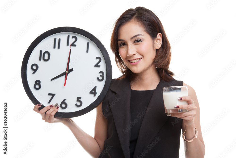 Healthy Asian woman drinking glass of milk hold clock. Healthy Asian woman drinking glass of milk hold clock.