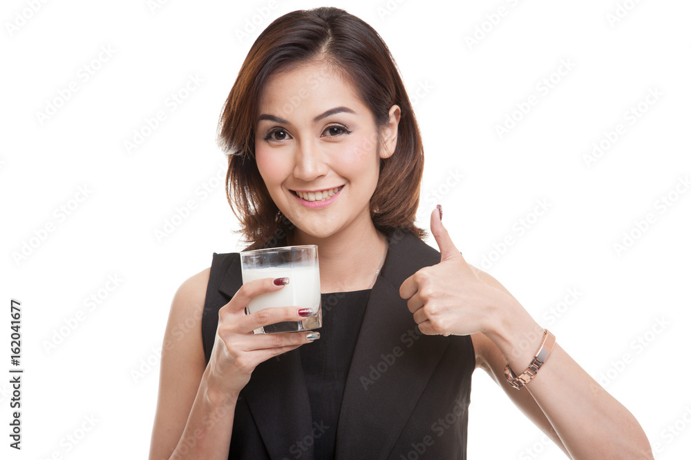 Healthy Asian woman drinking a glass of milk thumbs up. Healthy Asian woman drinking a glass of milk thumbs up.