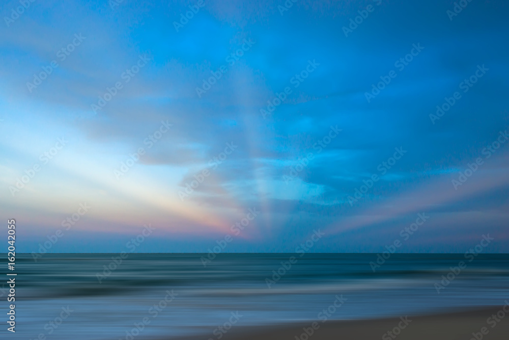 Seascape with sun beams at sunset