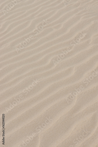 Lines in the sand of a beach. Out of focus image.