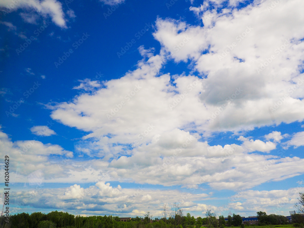 blue sky clouds and trees