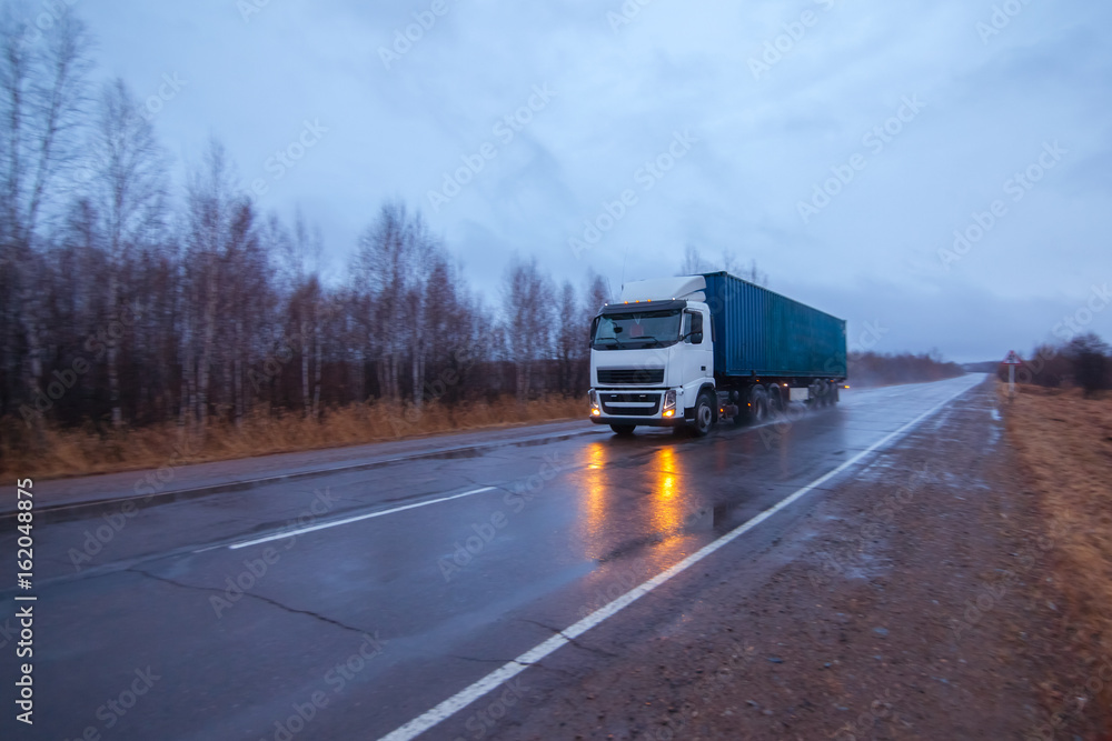 White truck on a road in early morning