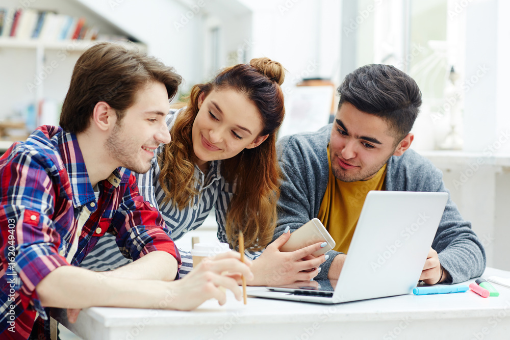 Business group with laptop consulting about new online statistics Business group with laptop consulting about new online statistics