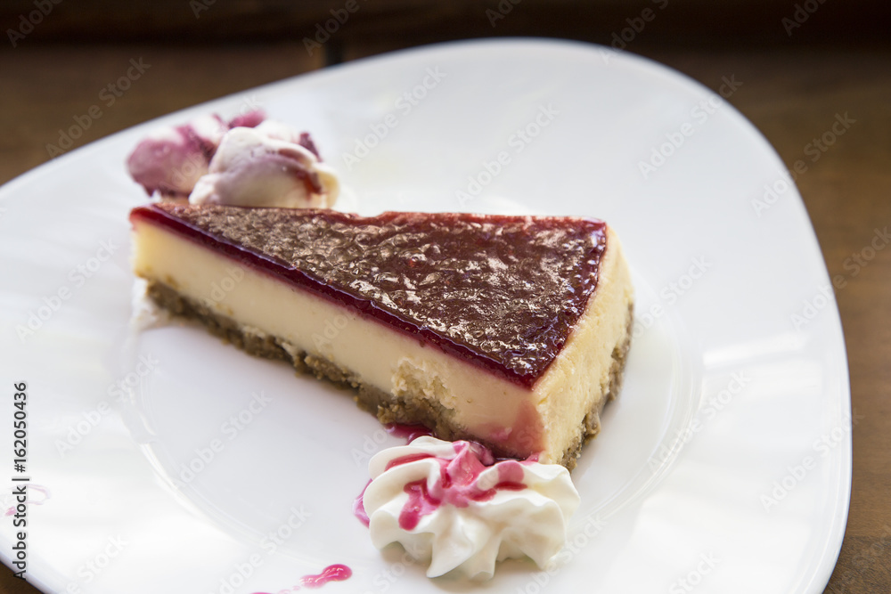 Fresh raspberry cheesecake on white plate Fresh raspberry cheesecake on white plate