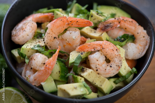 Salad with avocado, cucumber and tiger shrimps, close-up, selective focus, horizontal shot