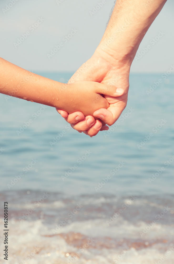 father holding  daughter hand