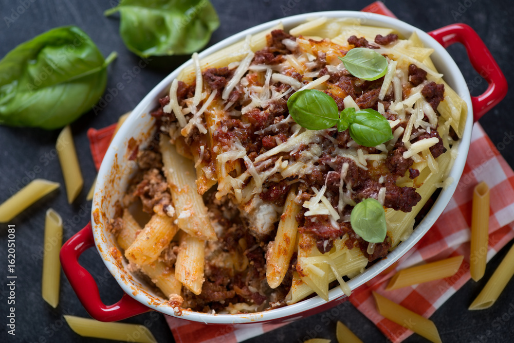Above view of a baking dish with italian traditional ziti, horizontal shot Above view of a baking dish with italian traditional ziti, horizontal shot