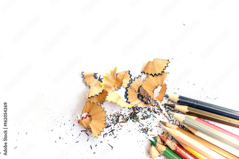 Wooden colorful pencils with sharpening shavings, on white paper Wooden colorful pencils with sharpening shavings, on white paper