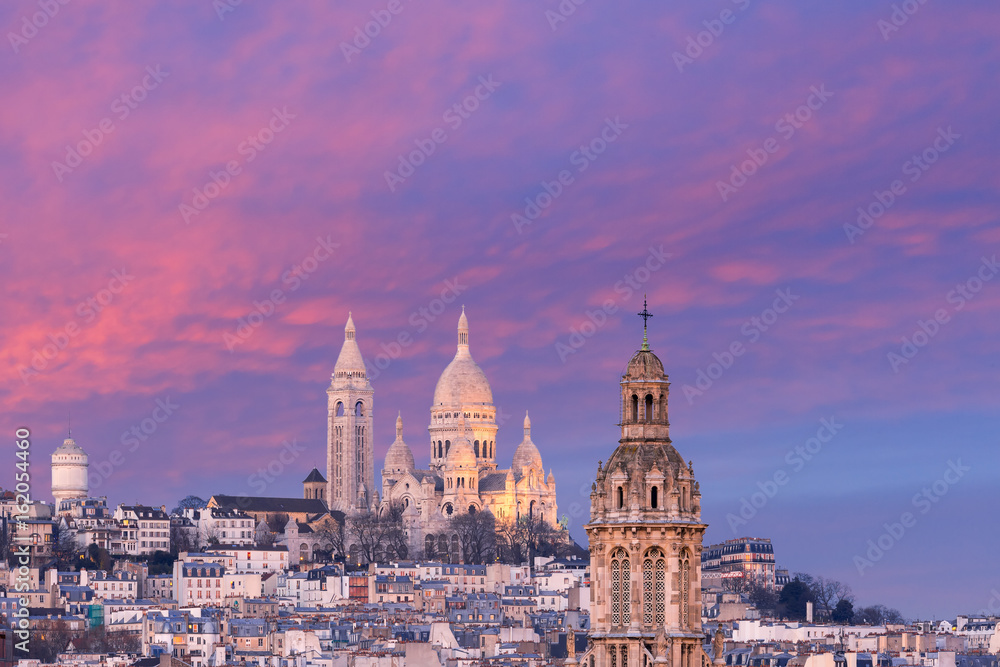 Aerial view of Sacre-Coeur Basilica or Basilica of the Sacred Heart of Jesus at the butte Montmartre and Saint Trinity church at nice sunset, Paris, France