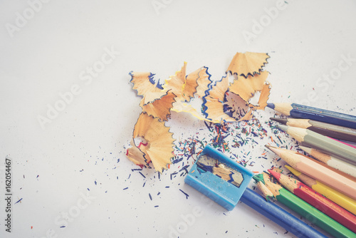 color pencil with sharpening shavings on white background,warm tone