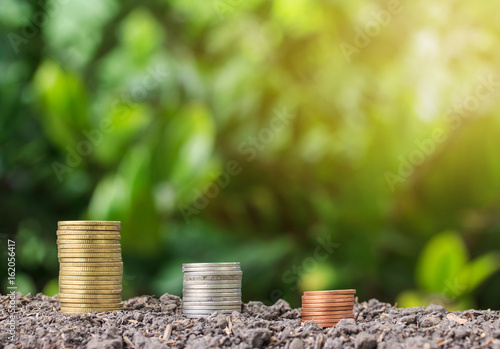 stacked coin on soil for nuture background