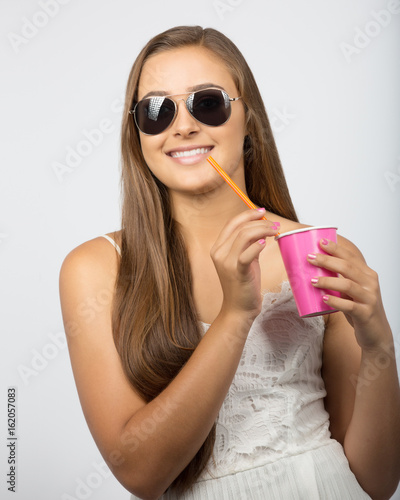 Teenager with drink and sunglasses