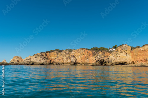 Scenic golden cliffs near Alvor, Portimao, Algarve © anammarques