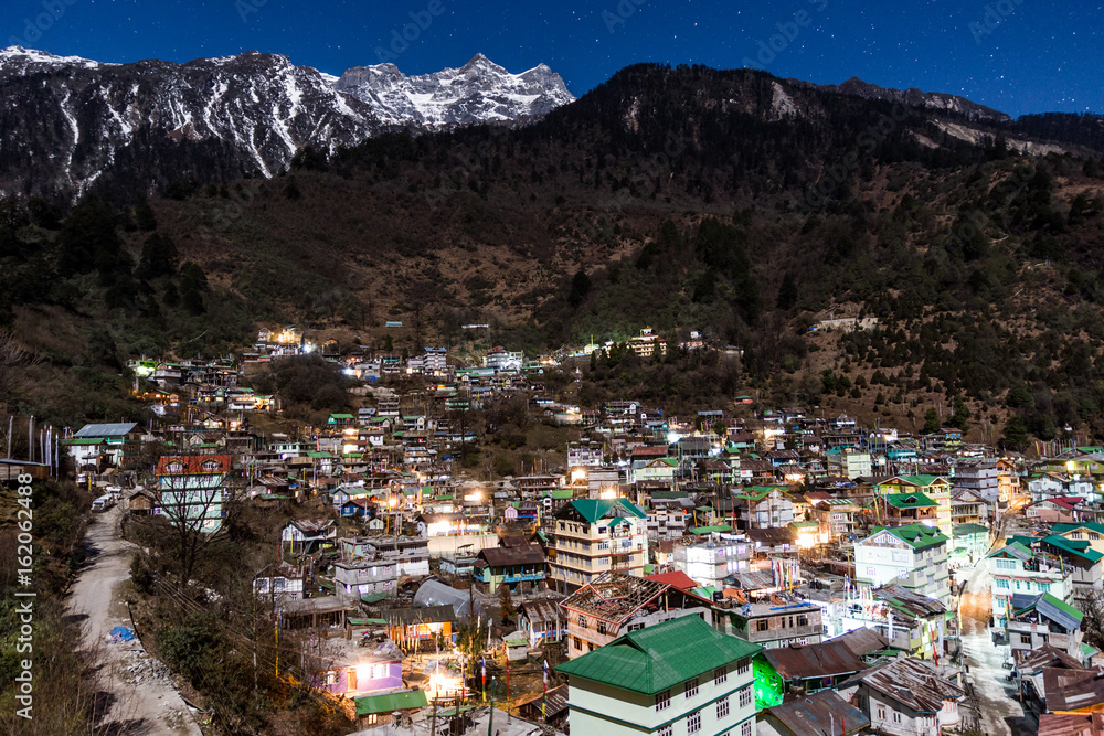 Mountain with little snow on the top with village in the night at Lachen in North Sikkim, India.