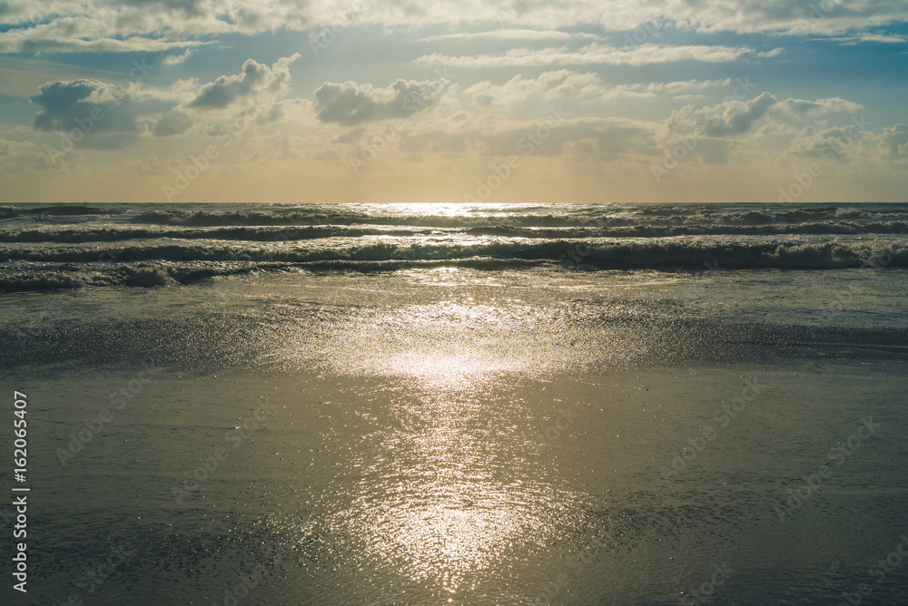 Sunlit waves at the beach.