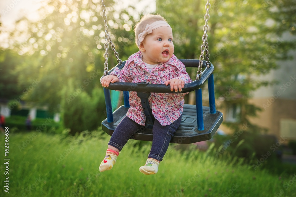 Baby fun riding on the swings at the Park. Baby fun riding on the swings at the Park.