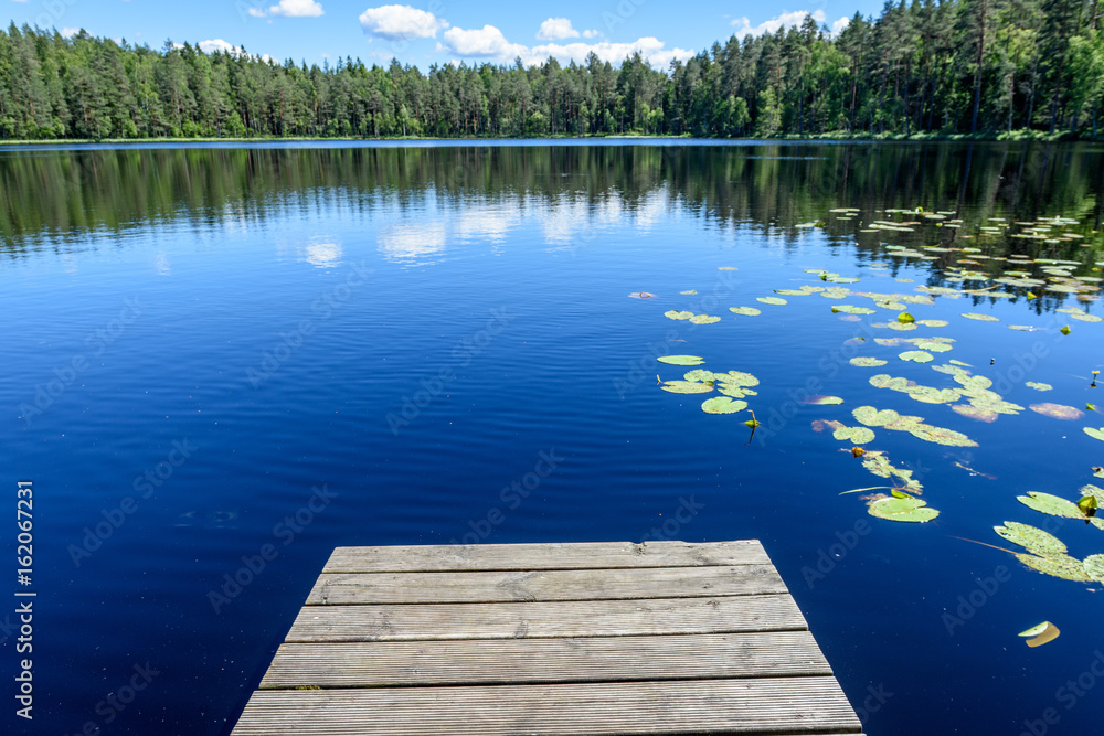 reflection of clouds in the lake with boardwalk reflection of clouds in the lake with boardwalk