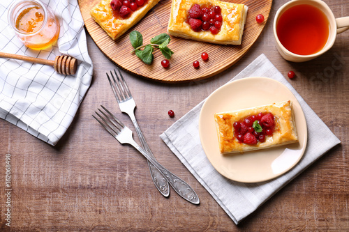 Delicious pastries with berries on served table