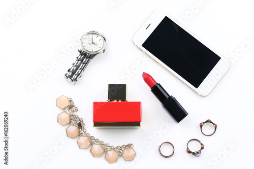 Perfume, accessories, cosmetics and phone on white background