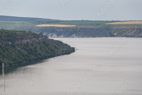 A view of river and hill. Blue sky.