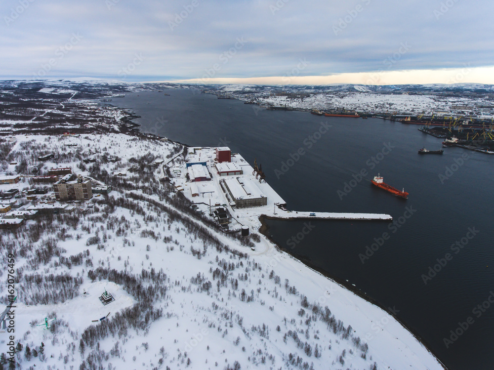 Obraz premium Beautiful aerial air winter vibrant view of Murmansk, Russia, a port city and the administrative center of Murmansk Oblast, Kola peninsula, Kola Bay, shot from quadcopter drone