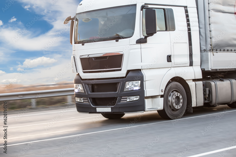 Naklejka premium truck transports freight on highway