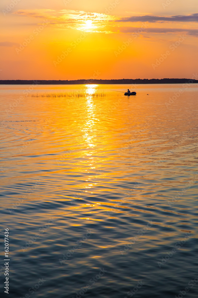 fisherman by boat fishes on lake fisherman by boat fishes on lake