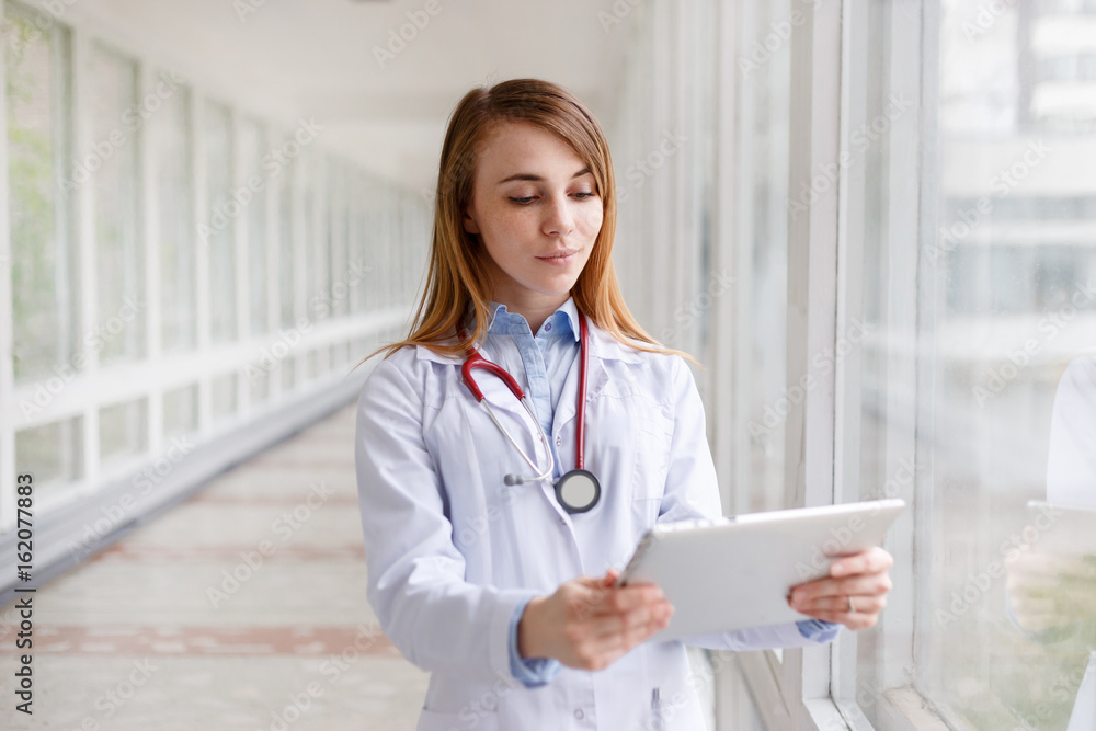 Portrait of modern female doctor with tablet Portrait of modern female doctor with tablet