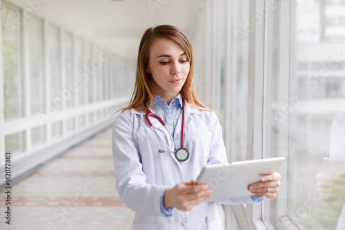 Portrait of modern female doctor with tablet